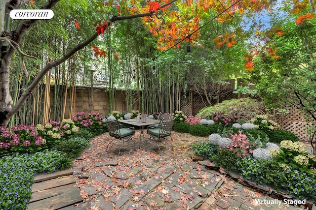 view of patio with fence and outdoor dining area