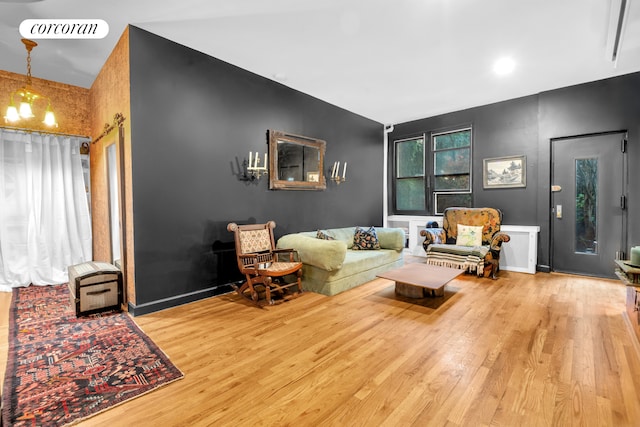 living room with visible vents, baseboards, and wood finished floors