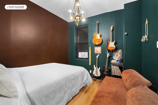 bedroom with an inviting chandelier and wood finished floors