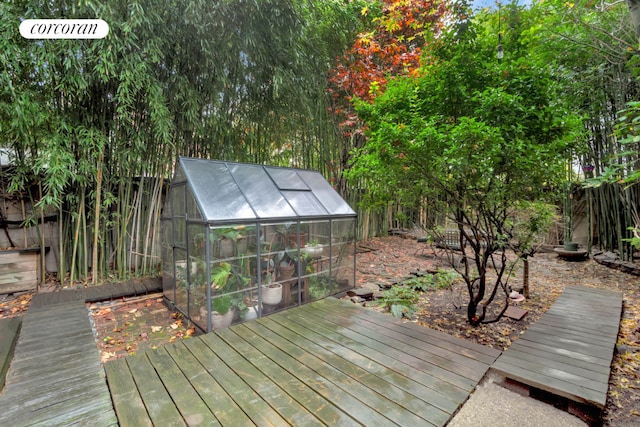 wooden terrace with an outbuilding