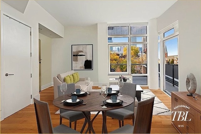 dining space with light wood-type flooring