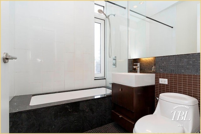 full bathroom featuring vanity, plenty of natural light, tile walls, and toilet