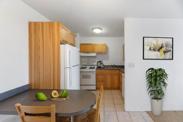 kitchen featuring sink, white appliances, and light tile patterned floors