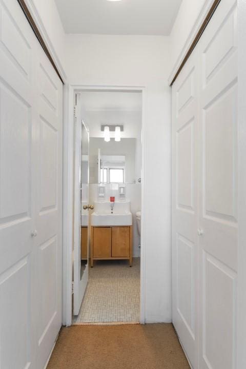 hall with light tile patterned floors