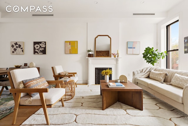 living area with a fireplace and wood finished floors