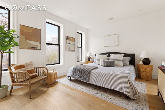 bedroom featuring baseboards and wood finished floors