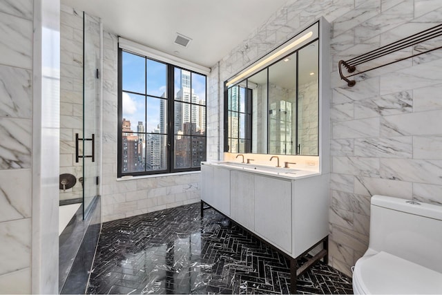 full bathroom featuring visible vents, toilet, a shower with door, tile walls, and vanity