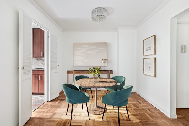 dining area featuring ornamental molding and light parquet flooring