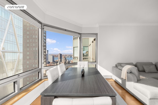 dining space with a city view and ornamental molding