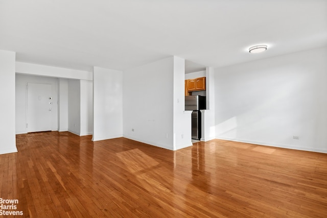 empty room with light hardwood / wood-style flooring