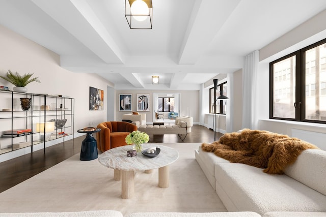 living area with wood finished floors, beamed ceiling, coffered ceiling, and baseboards