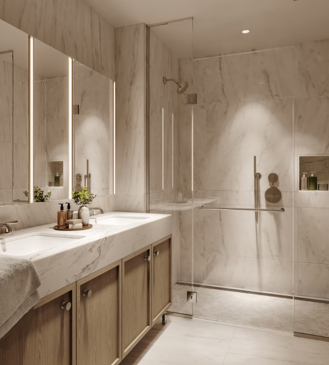 bathroom featuring a shower with shower door, vanity, and tile walls