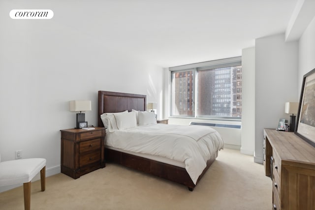 bedroom with light colored carpet, visible vents, and baseboards