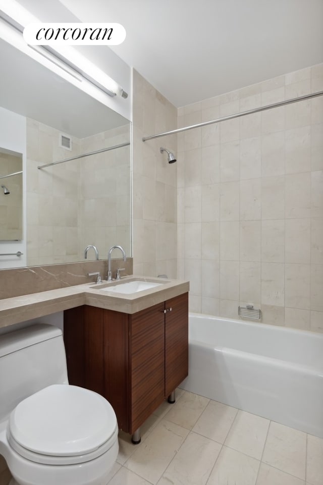 full bath with bathtub / shower combination, toilet, tile patterned flooring, tile walls, and vanity