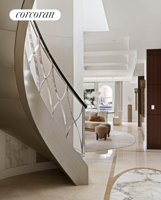 staircase with a raised ceiling