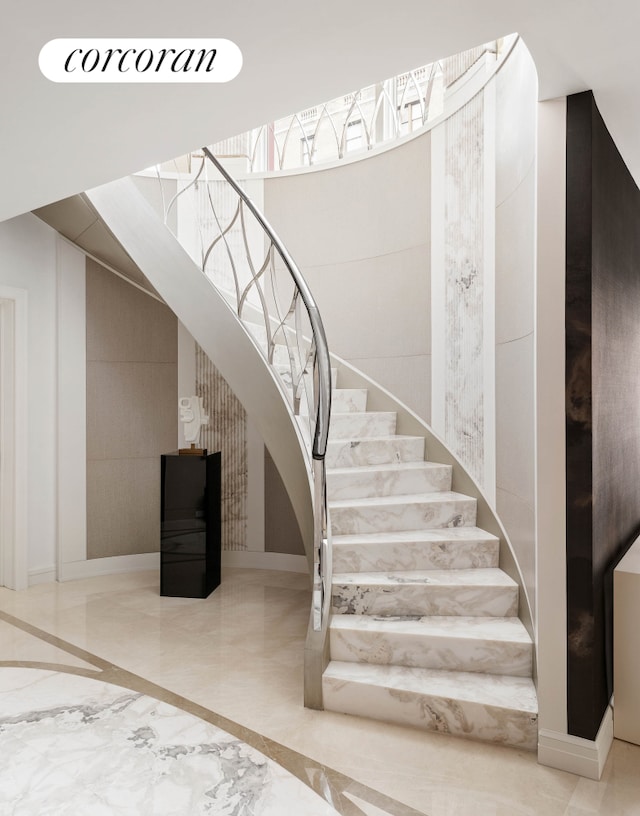 stairs featuring marble finish floor and baseboards