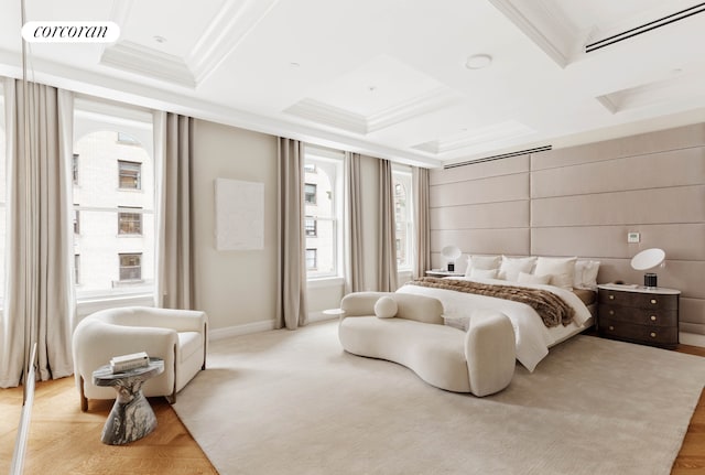 bedroom with ornamental molding, coffered ceiling, and visible vents