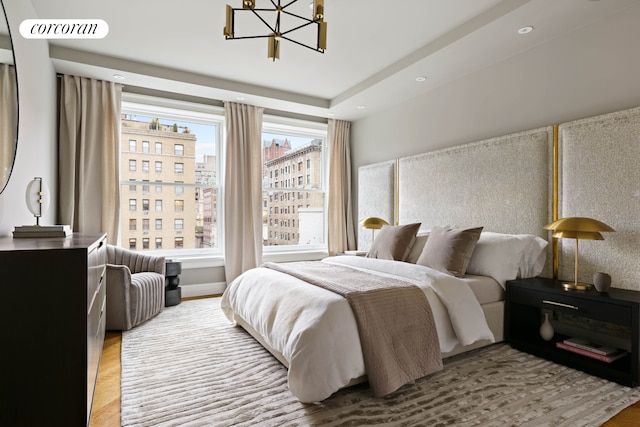 bedroom with recessed lighting, a city view, visible vents, and an inviting chandelier