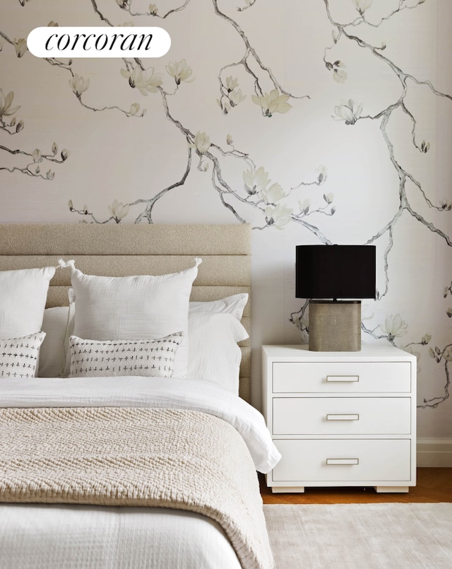 bedroom featuring wood finished floors and baseboards