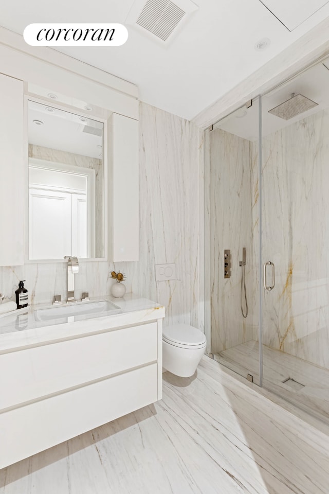 bathroom with a marble finish shower, visible vents, toilet, marble finish floor, and vanity