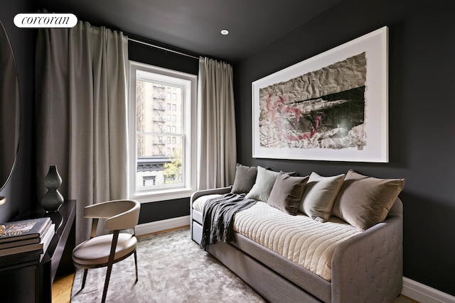 sitting room featuring light wood finished floors and baseboards