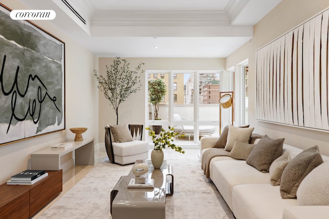 living area featuring visible vents and ornamental molding