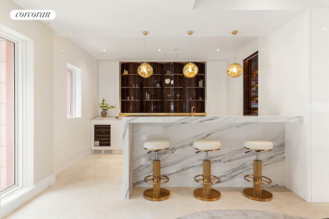 bar featuring decorative light fixtures, recessed lighting, visible vents, beverage cooler, and baseboards