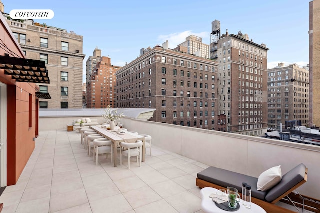 view of patio with a city view and outdoor dining space