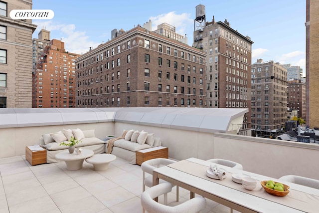 view of patio featuring a view of city, outdoor lounge area, and a balcony