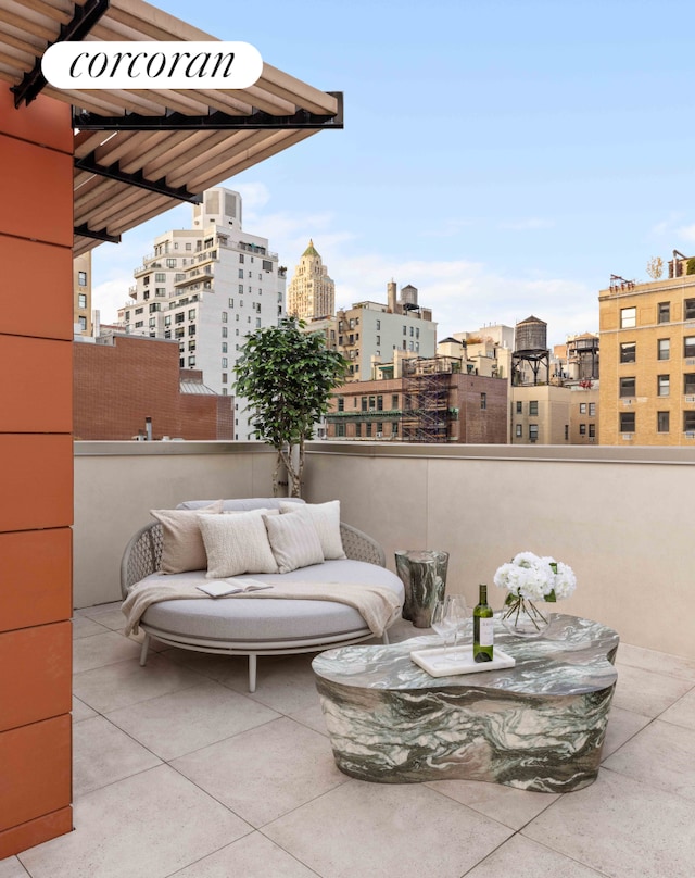 view of patio with a balcony and a city view