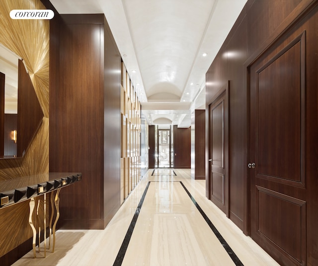 corridor with recessed lighting and a tray ceiling