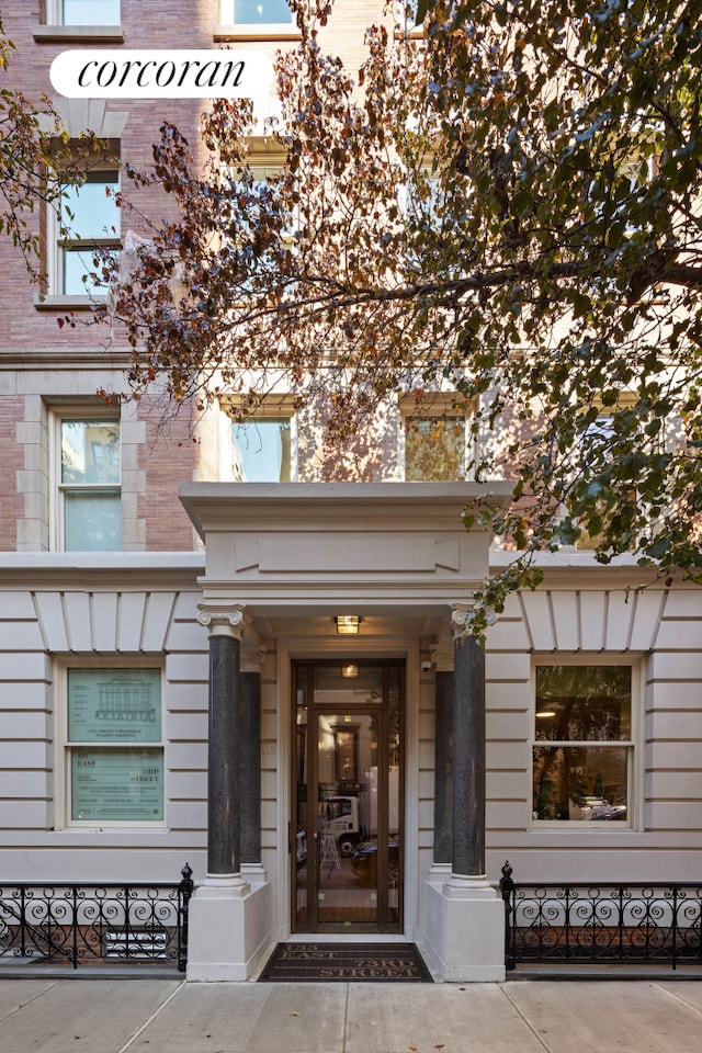 view of exterior entry with brick siding