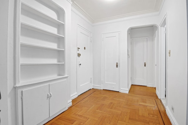 corridor with light parquet floors and ornamental molding