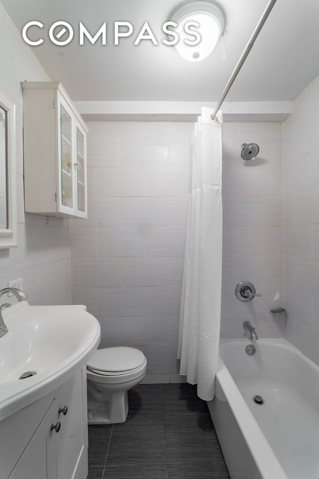 155 E 49th St Unit 10E, New York City, NY 10017 - full bathroom with vanity, shower / tub combo with curtain, tile walls, toilet, and tile patterned floors