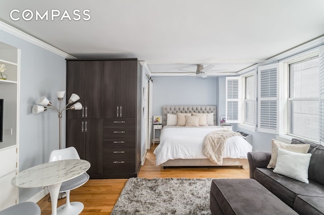 155 E 49th St Unit 10E, New York City, NY 10017 - bedroom with light wood-type flooring, ornamental molding, and a ceiling fan