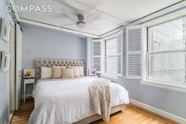 155 E 49th St Unit 10E, New York City, NY 10017 - bedroom featuring wood finished floors, baseboards, and ceiling fan