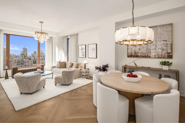 dining space with a chandelier, a view of city, and baseboards