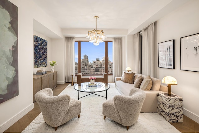 201 E 74th St Unit 5A, New York City, NY 10021 - living area with a chandelier, baseboards, and a view of skyline