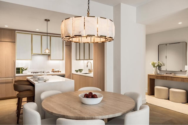 dining area with sink and a chandelier