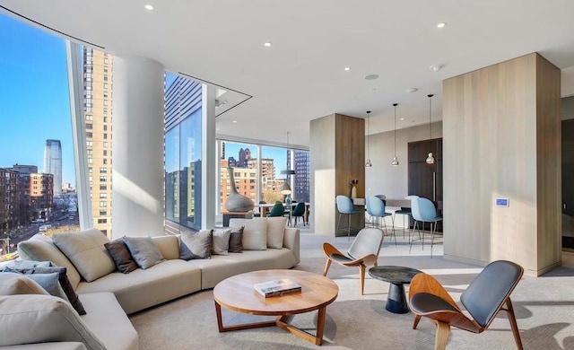 carpeted living area featuring recessed lighting, floor to ceiling windows, and a city view