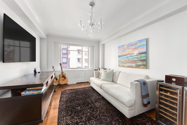 living room with ornamental molding, hardwood / wood-style floors, wine cooler, and an inviting chandelier