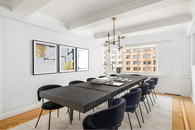 dining room with an inviting chandelier, beam ceiling, ornamental molding, and light parquet floors