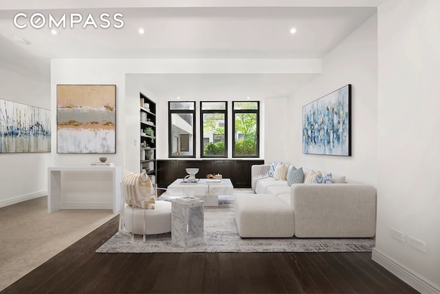 living area featuring built in shelves, baseboards, dark wood-type flooring, and recessed lighting