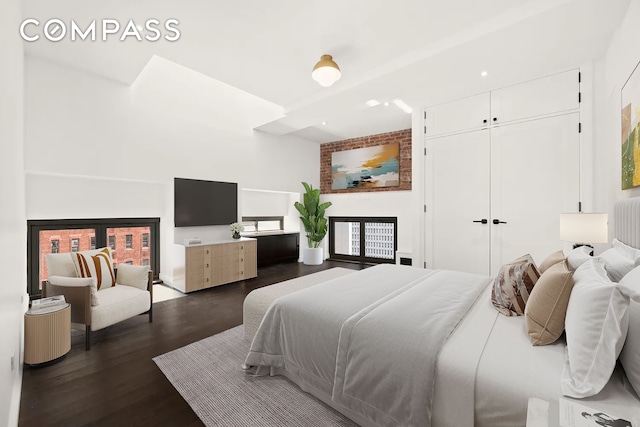 bedroom featuring dark wood-type flooring and a closet