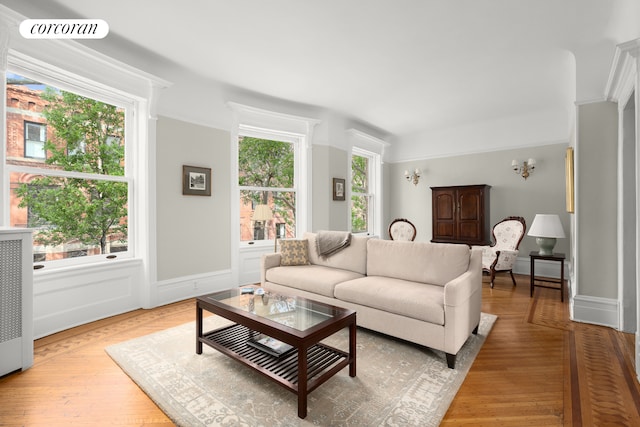 living room featuring baseboards, visible vents, and light wood-style floors