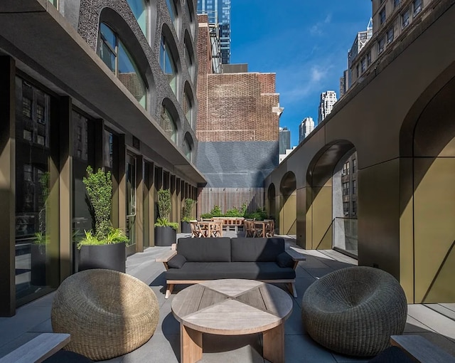 view of patio / terrace featuring outdoor dining space, an outdoor living space, a city view, and fence