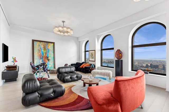 living room featuring light wood-style flooring and an inviting chandelier