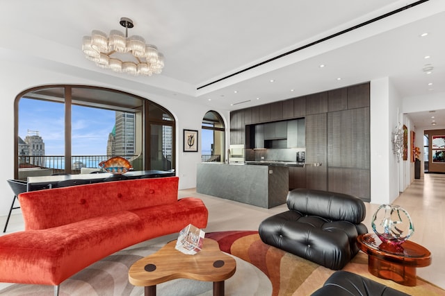 living room with recessed lighting, arched walkways, and a chandelier