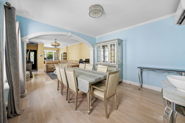 dining space featuring crown molding, an AC wall unit, and light wood-type flooring