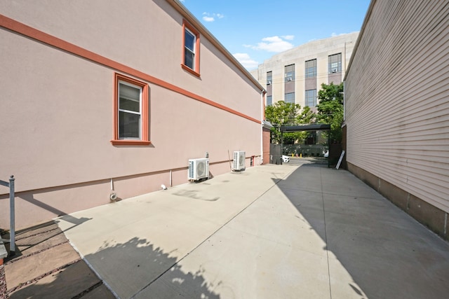 view of patio with central AC unit and ac unit